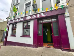 Entrance of to the vibrant local bar named Max Bar with colorful decorations.