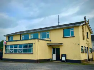 Yellow building with blue windows. This is the Lantern Bar in Ballyshannon.